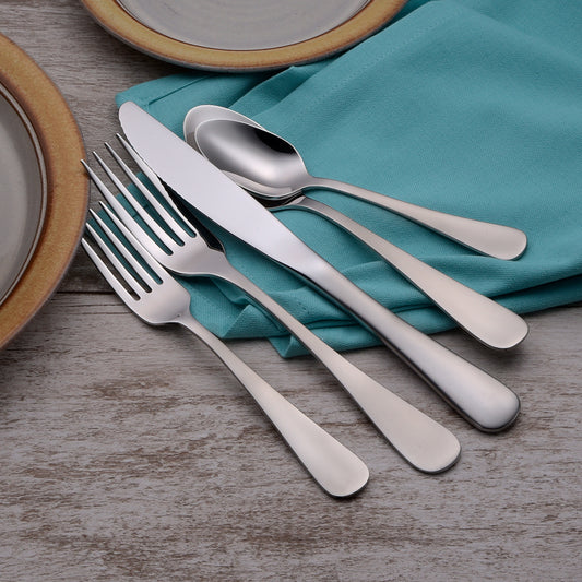 Silverware set including a knife, fork, and spoon on a teal napkin.