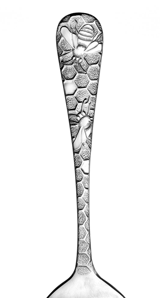 Close-up of a spoon handle with honeycomb and bee design from the Honey Bee 65 Piece Set