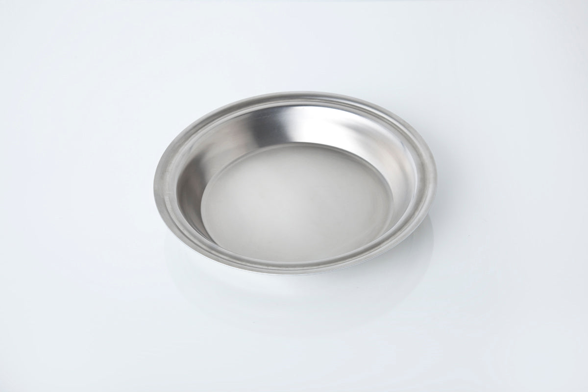Stainless steel pie pan on a white background