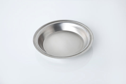 Stainless steel pie pan on a white background