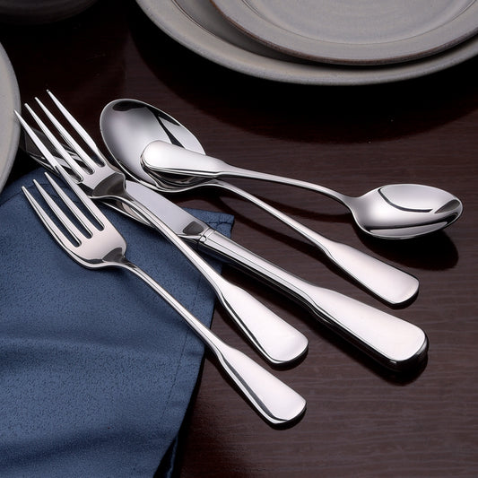 Five pieces of Susanna flatware including forks and spoons on a table setting with a blue napkin.