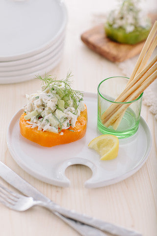 Cucumber crab salad served on a tomato slice with dill and breadsticks