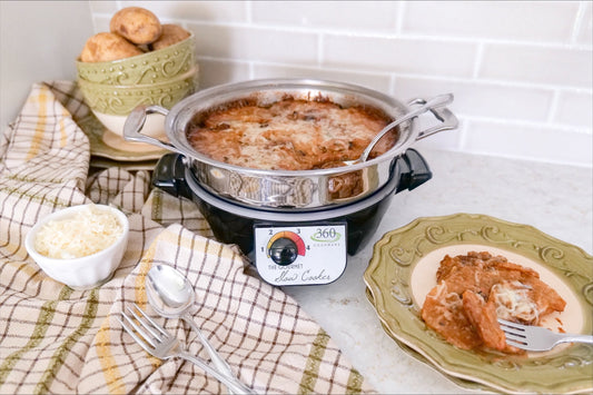 Scalloped potatoes served from a slow cooker with a plated portion, shredded cheese, and kitchen towels on a countertop