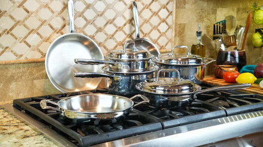stainless steel cookware set on a stove top