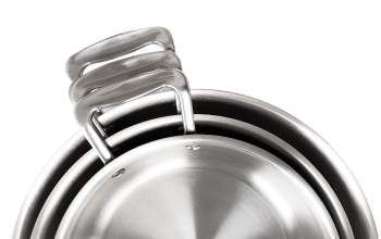 Top view of three nested stainless steel frying pans showcasing curved welded handles on a plain background