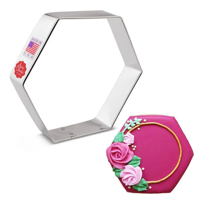 Hexagon cookie cutter with decorated cookie featuring pink roses