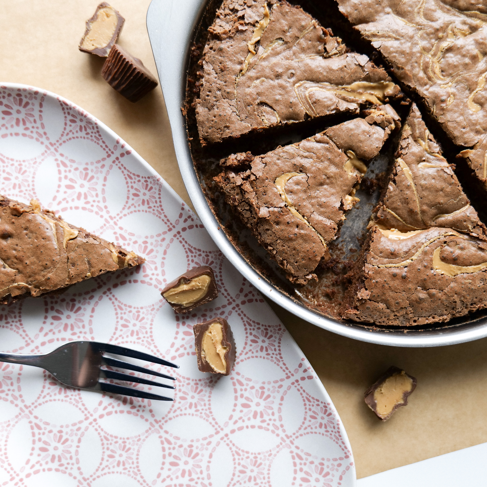 Sliced brownie with peanut butter cups on a decorative plate