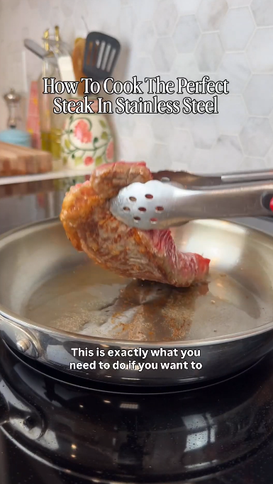 Steak flipped in a stainless steel pan for cooking the perfect steak