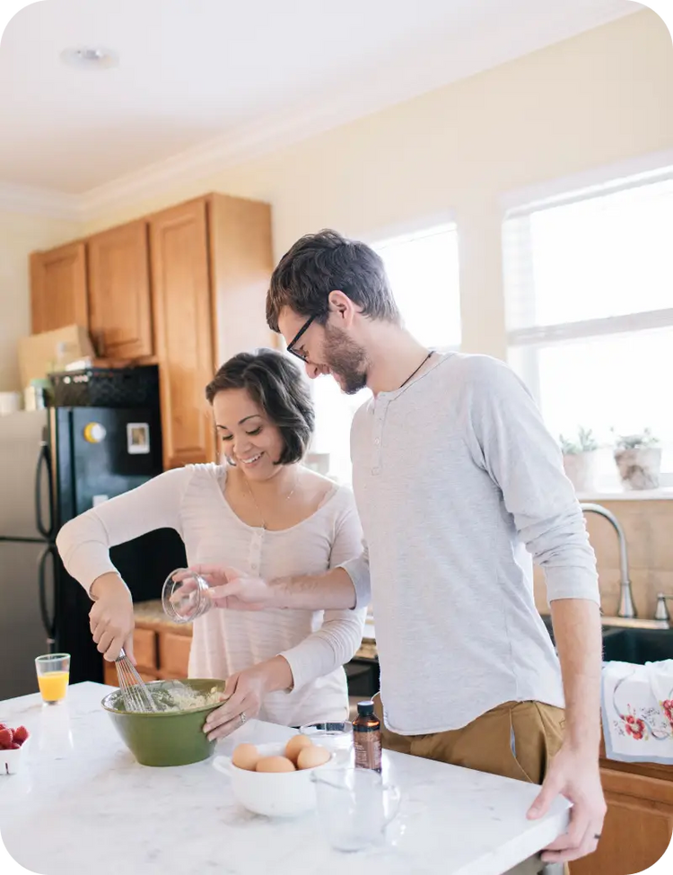 Couple baking in the kitchen.