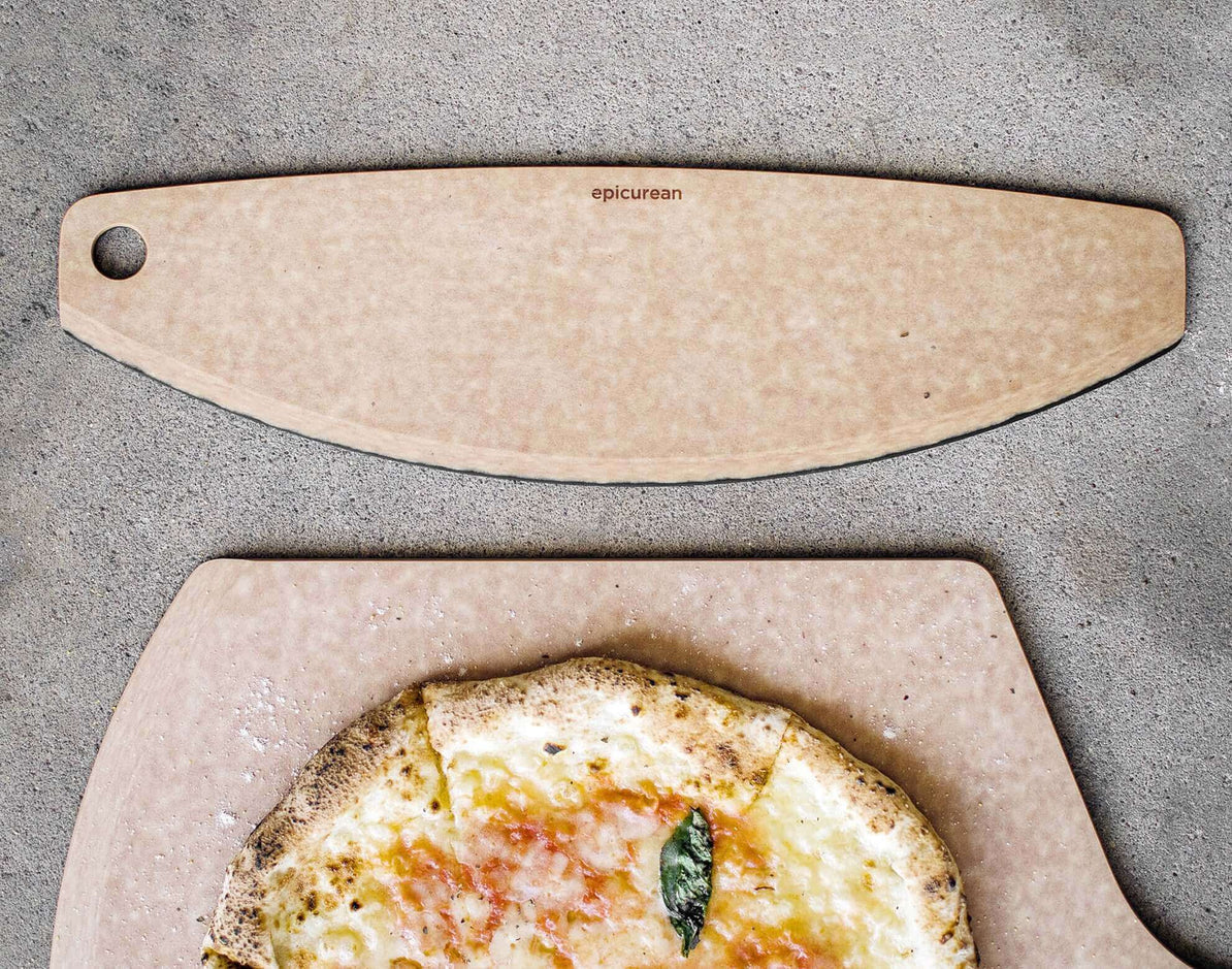 360 Cookware pizza cutter on a countertop with a pizza