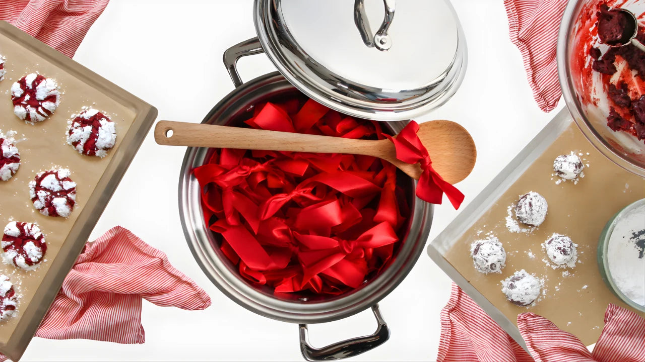 Stovetop with red fabric and wooden spoon, surrounded by baking trays with cookies.