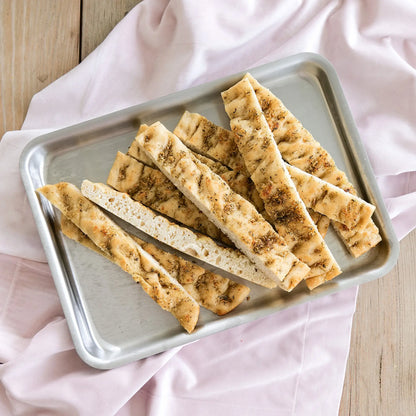 Bread sticks in a stainless steel jelly roll pan