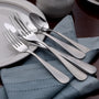 Angled overhead of Satin Annapolis flatware set showing satin finish on forks, knives, and spoons on a blue napkin