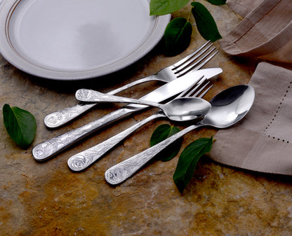 Earth Pattern Flatware set displayed on a table with leaves and a plate