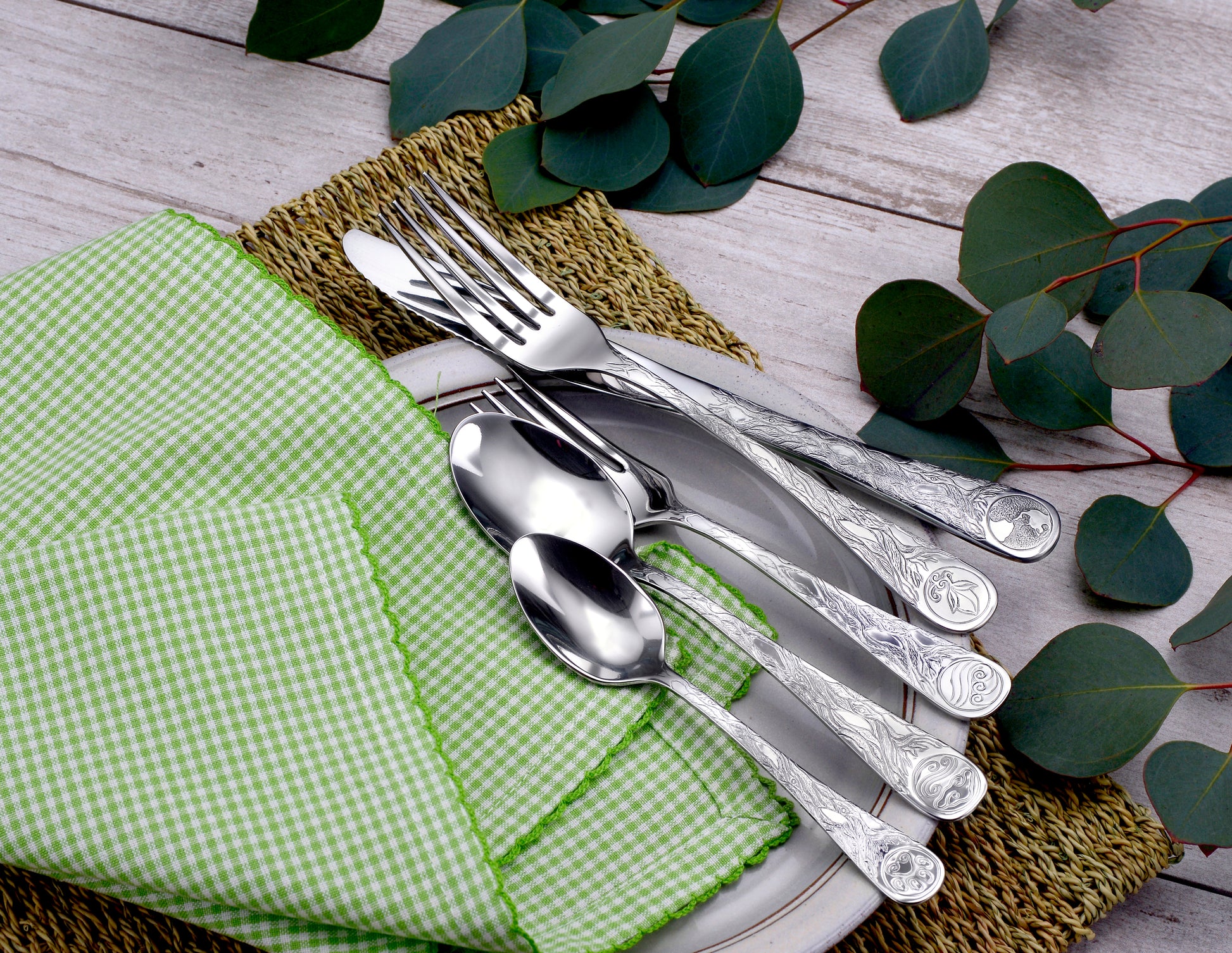 Earth - 45 Piece Set displayed with utensils on a plate and a green napkin