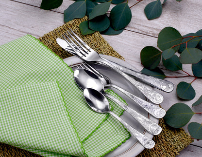 Earth - 45 Piece Set displayed with utensils on a plate and a green napkin