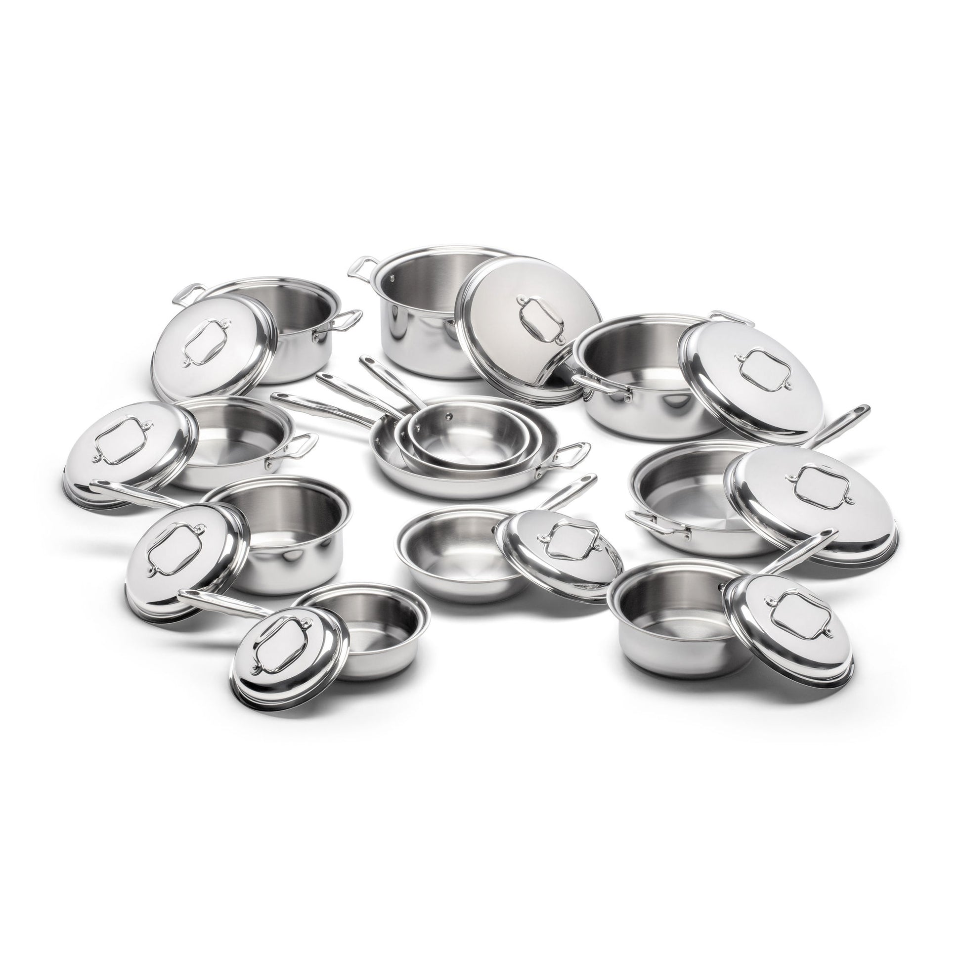 Collection of stainless steel cookware including saucepans and lids.