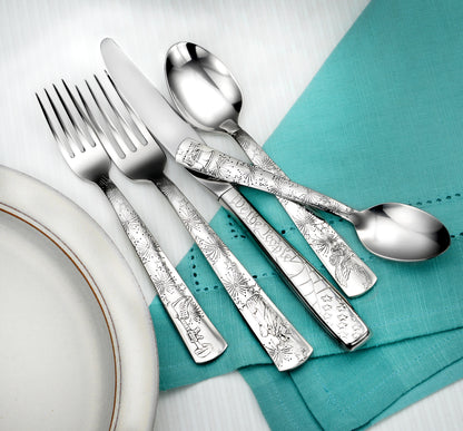 Liberty- 45 Piece Set featuring forks, knives, and spoons on a teal napkin
