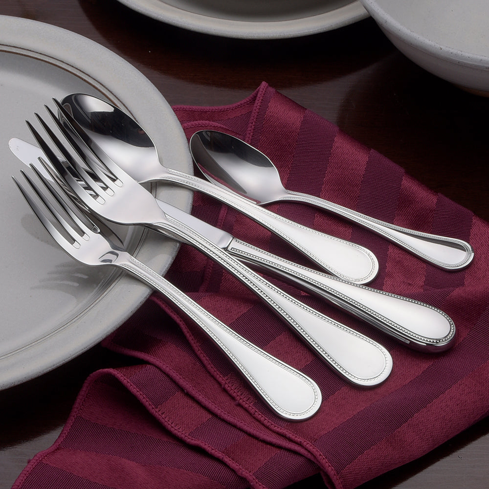 Pearl- 45 Piece Set displayed with forks and spoons on a table setting