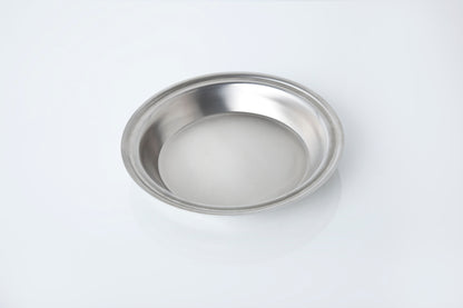 Stainless steel pie pan on a white background