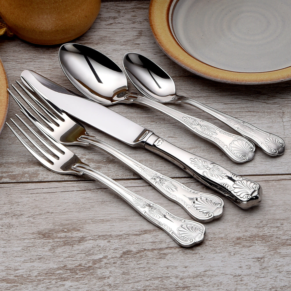 Sheffield 65 Piece Set featuring forks, knives, and spoons on a wooden table