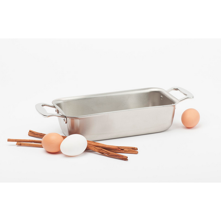 Stainless steel loaf pan with eggs and cinnamon sticks