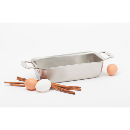 Stainless steel loaf pan with eggs and cinnamon sticks
