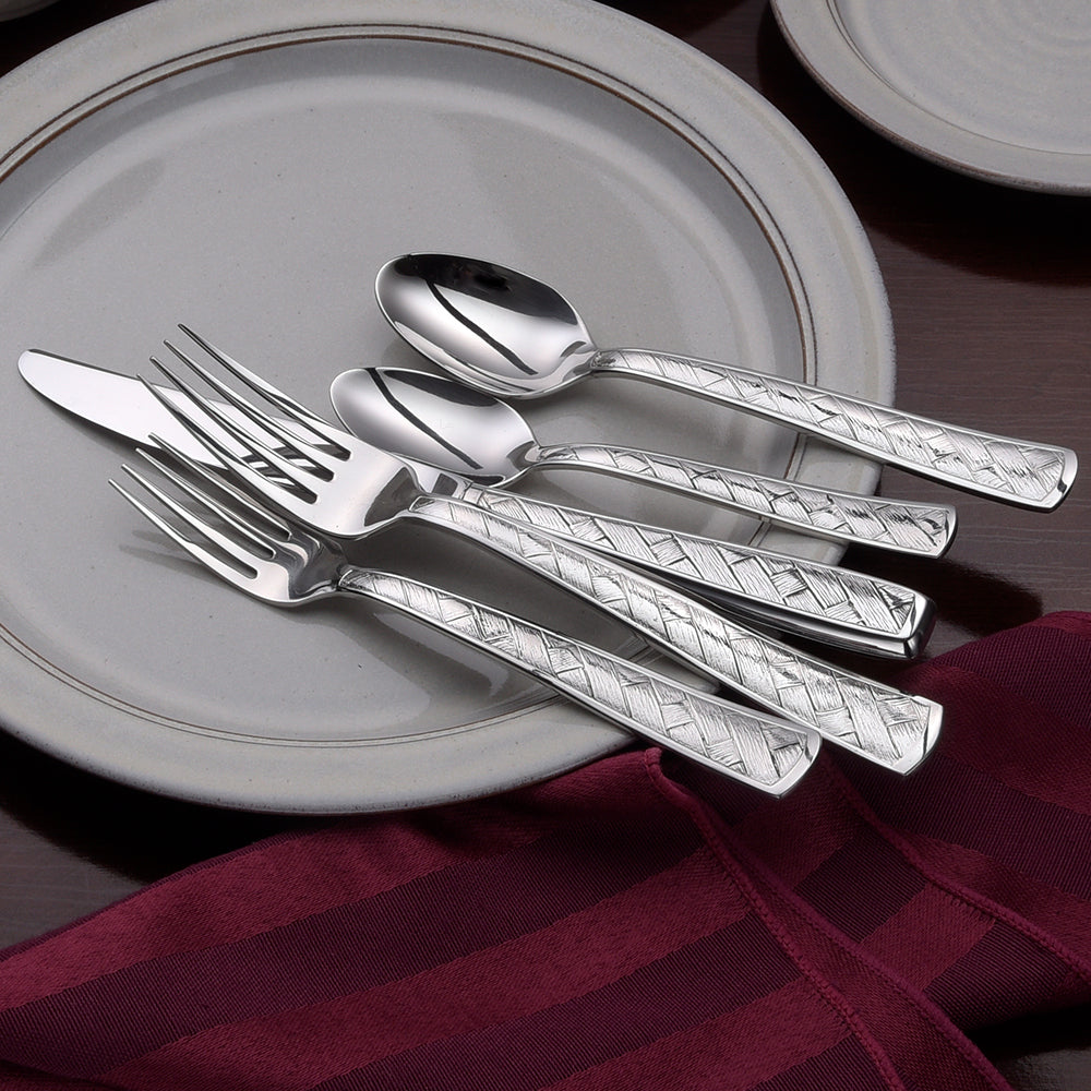 Weave 45 Piece Set flatware with distinctive basket design on a plate