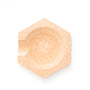 Top-down view of light wooden hexagonal dish with round shallow bowl and a small handle notch.