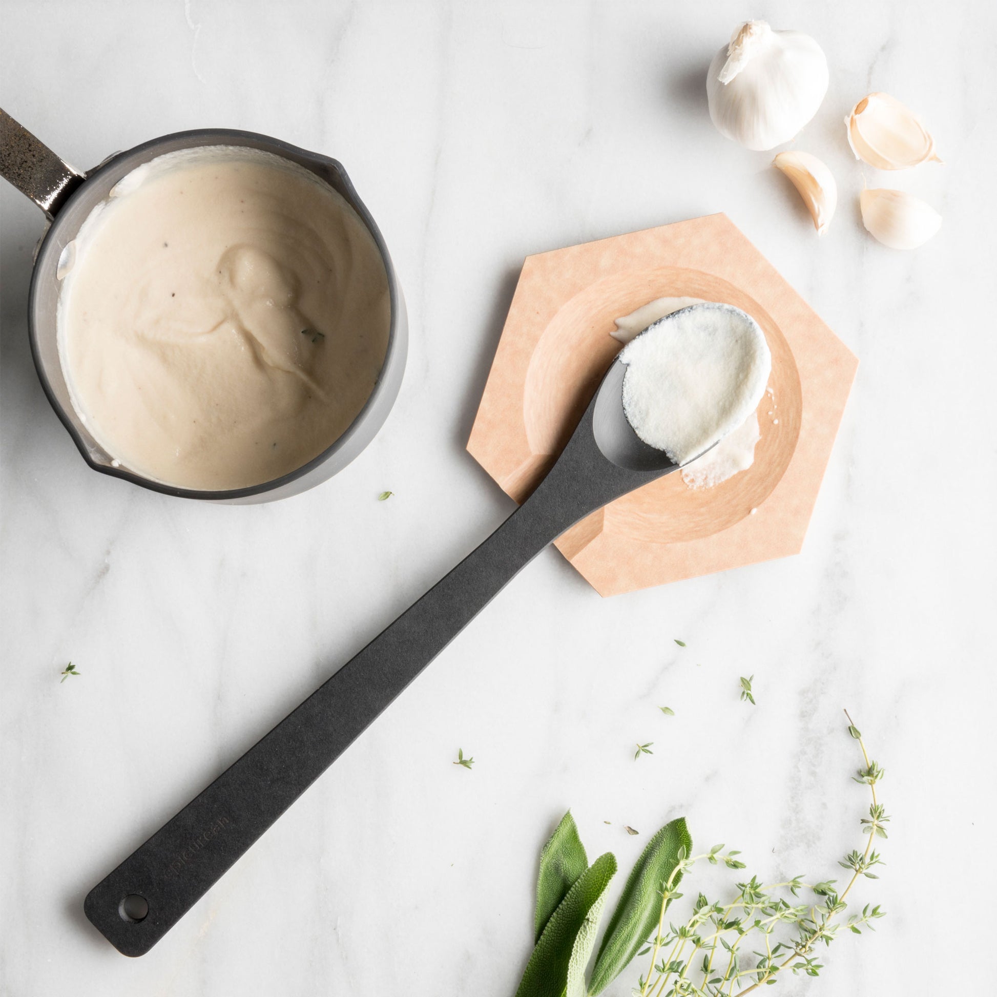 Hex Tool Rest in natural color with a spoon and ingredients on a marble surface